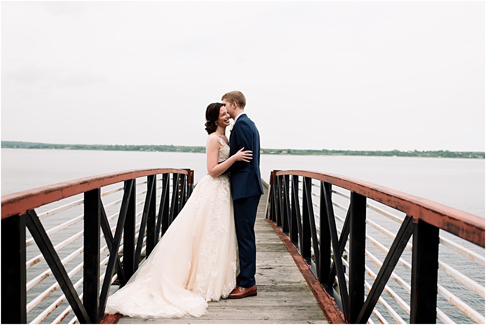 bride and groom on dock photo by Lisa Frechette Photography