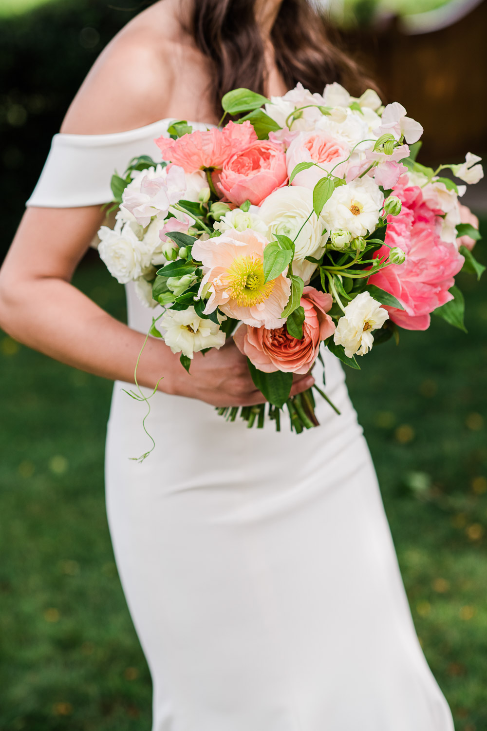 bride holding pink and white bouquet at the Saltwater Farm Vineyard