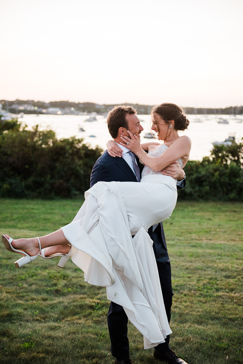 groom lifting bride looking at each other at sunset on Block Island at the Sullivan House