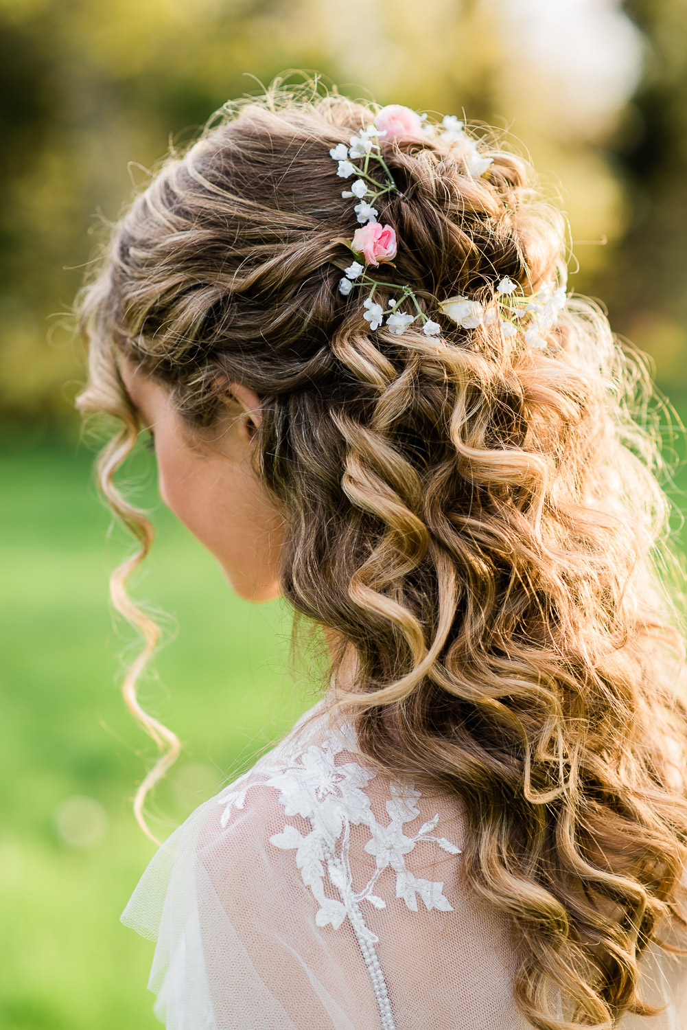 wavy bridal hairstyle with bun and flower crown