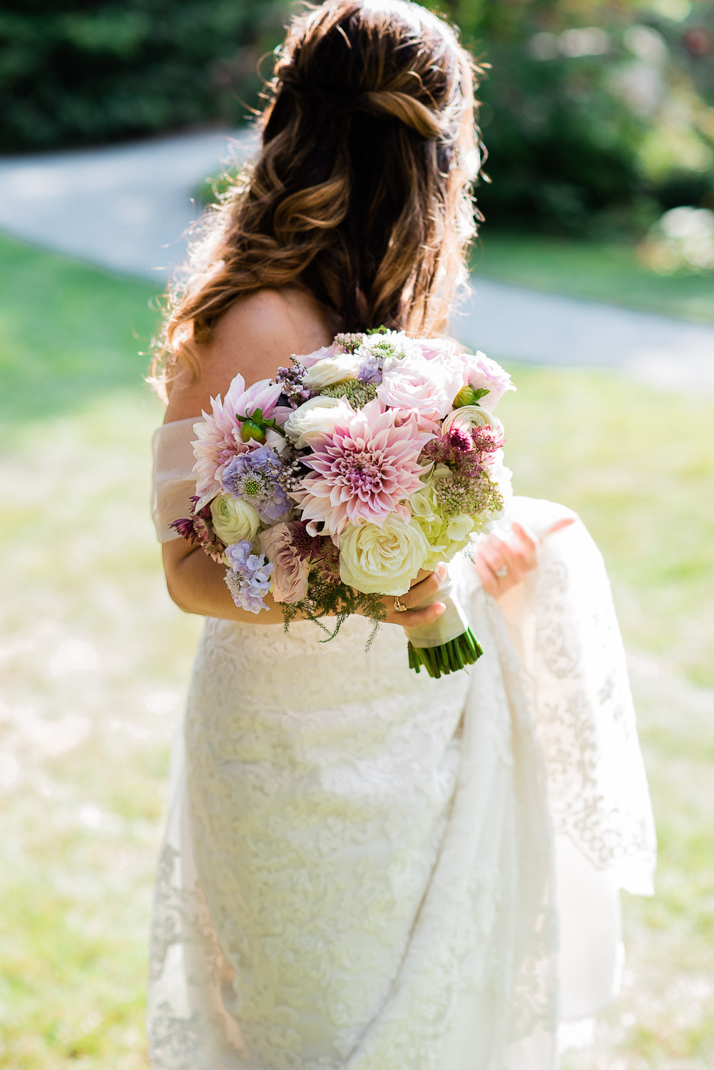 bride with pink and purple bouquet at Blithewold Mansion