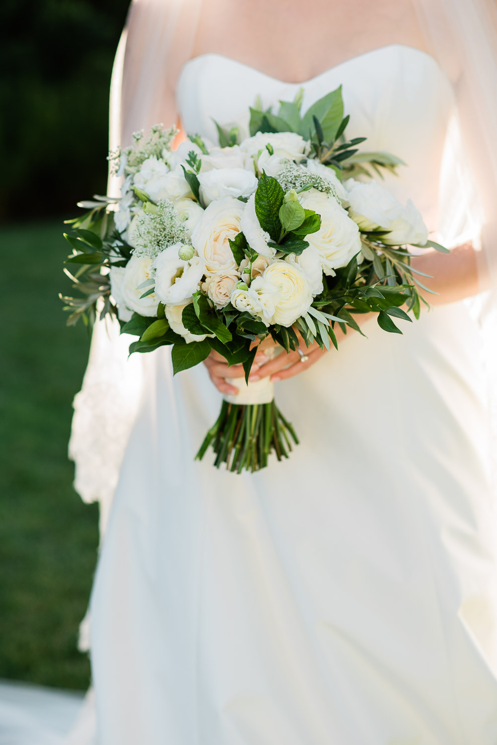 bride holding green and white floral bouquet at Ocean House