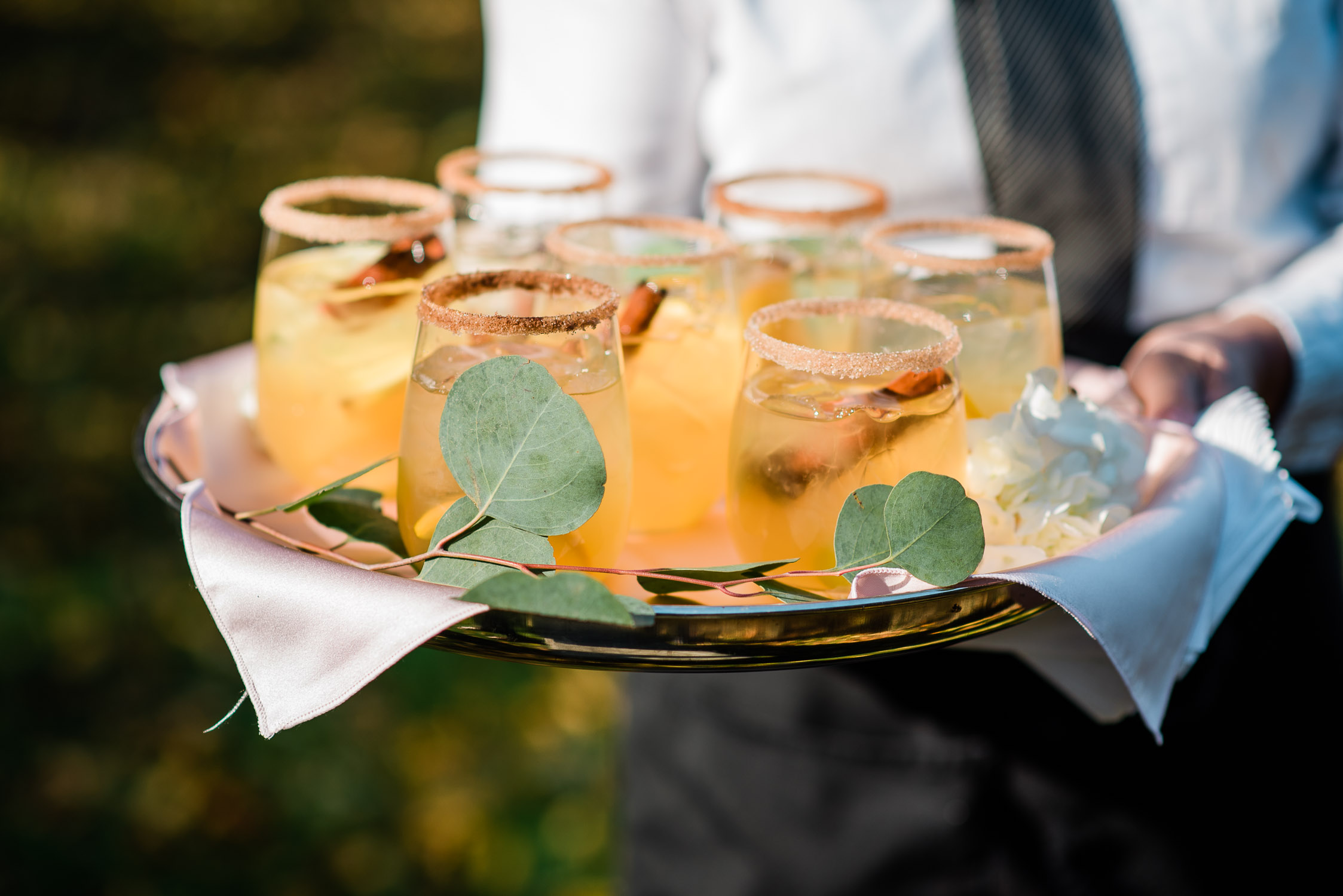 tray of orange signature cocktail drinks with cinnamon sticks at Glen Manor House