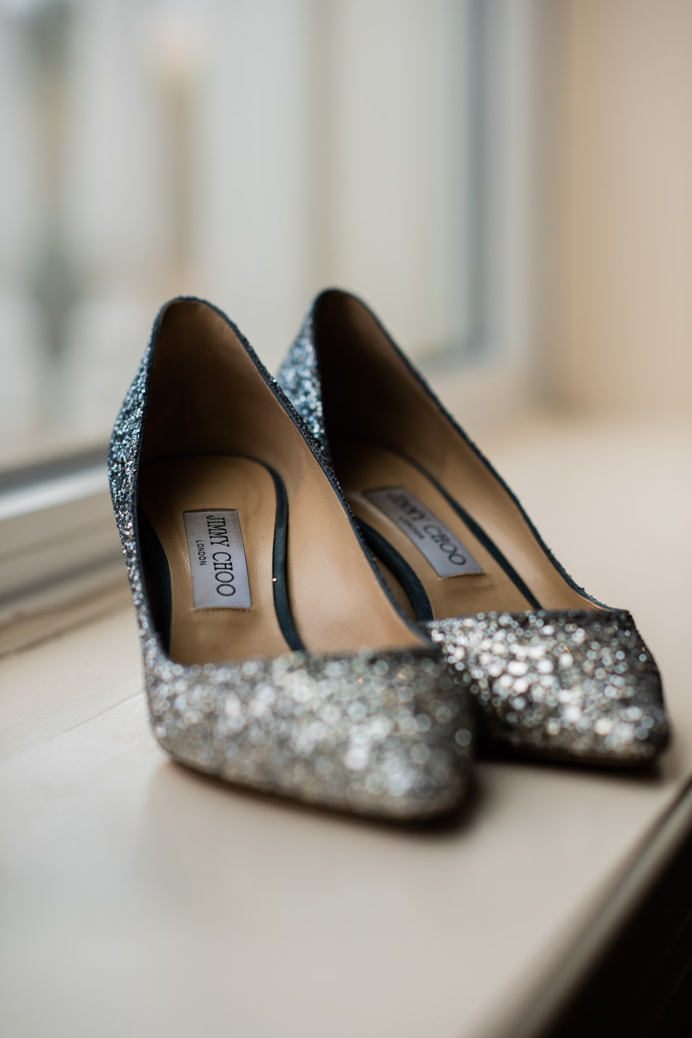 silver sequin Jimmy Choo bridal shoes by window