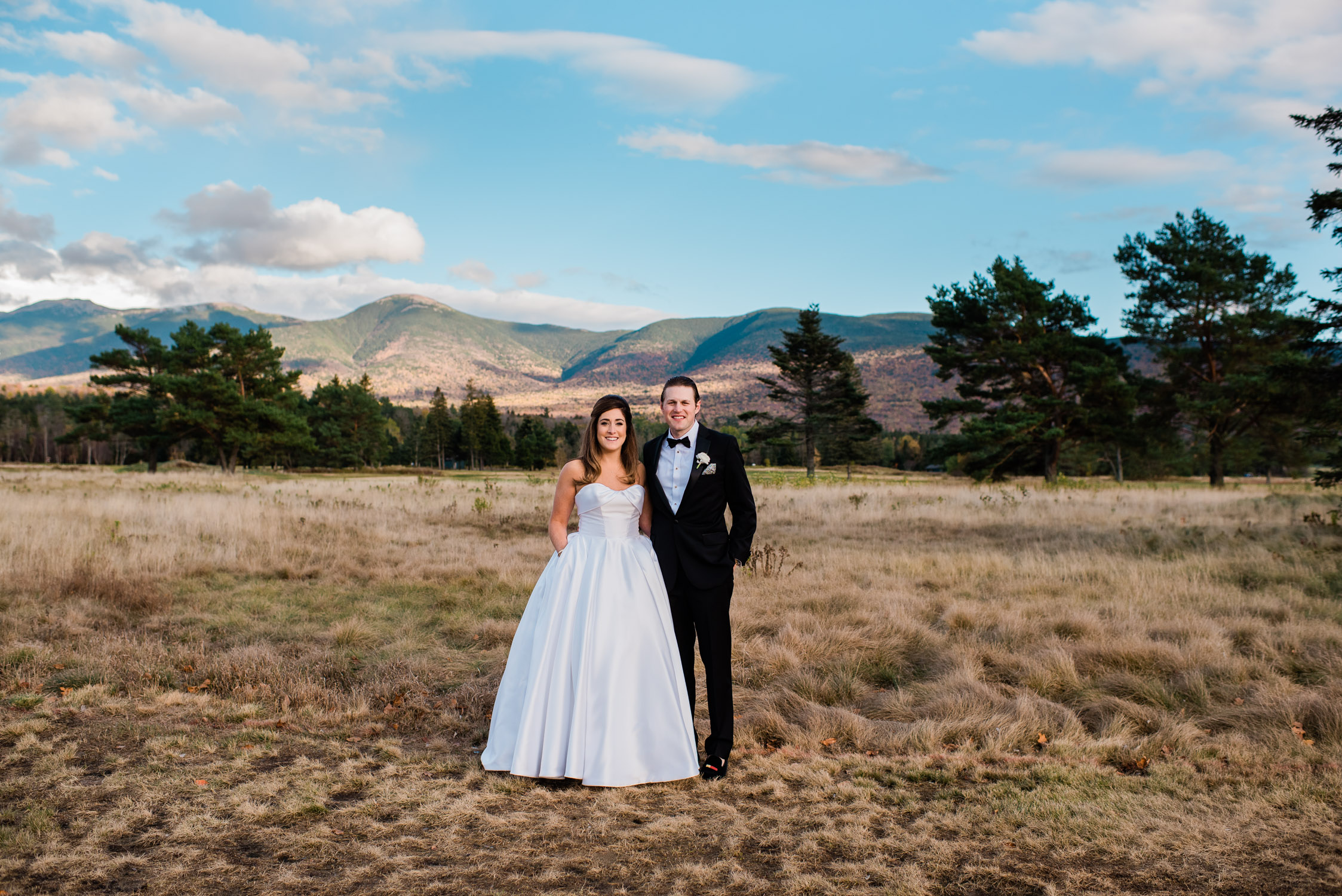 bride and groom in front of a mountain at the Omni Mount Washington Resort Hotel