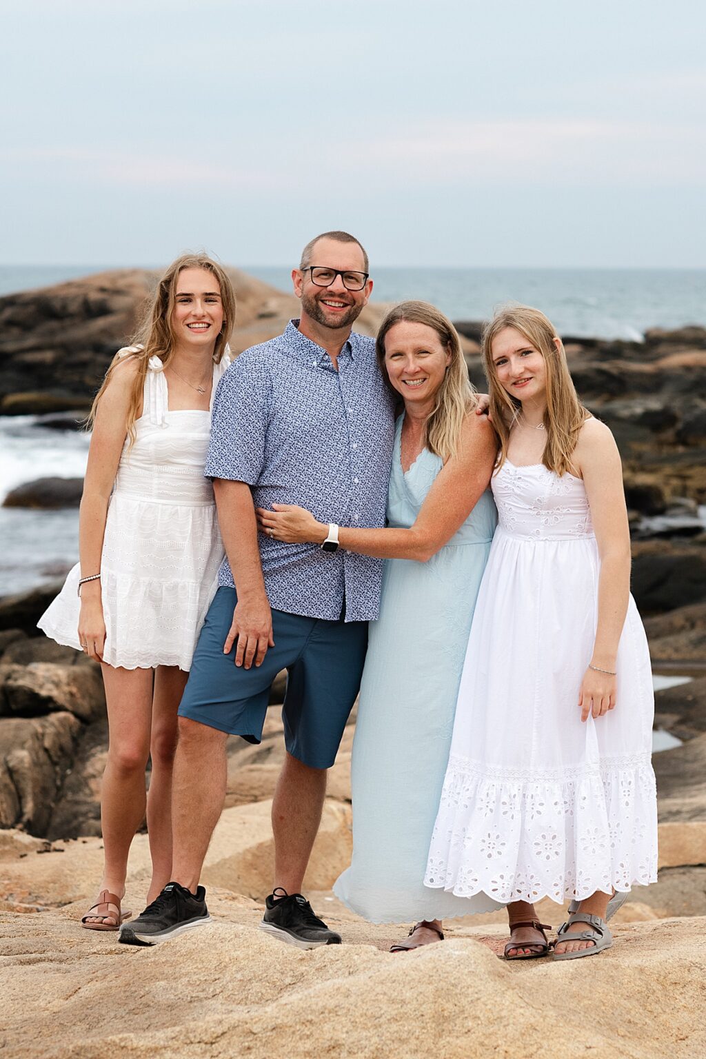 Family laughing together during a coastal portrait session in Narragansett