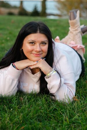 Warwick RI senior portrait of a high school senior lying on grass at Rocky Point State Park