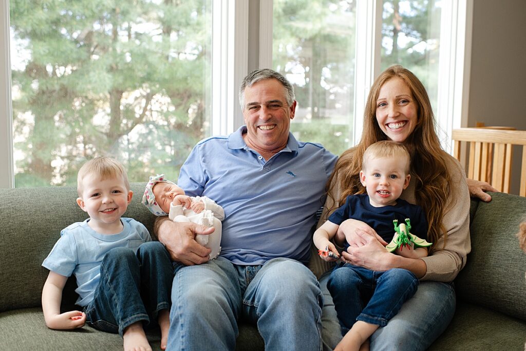 family portrait on couch with newborn