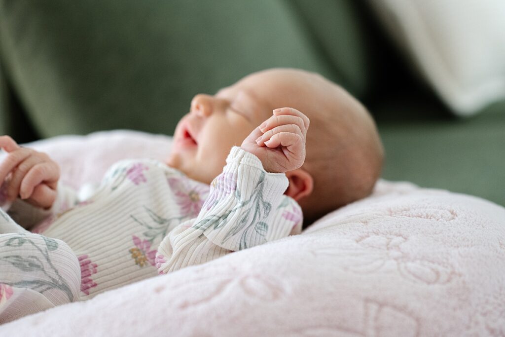 newborn baby asleep on pink blanket