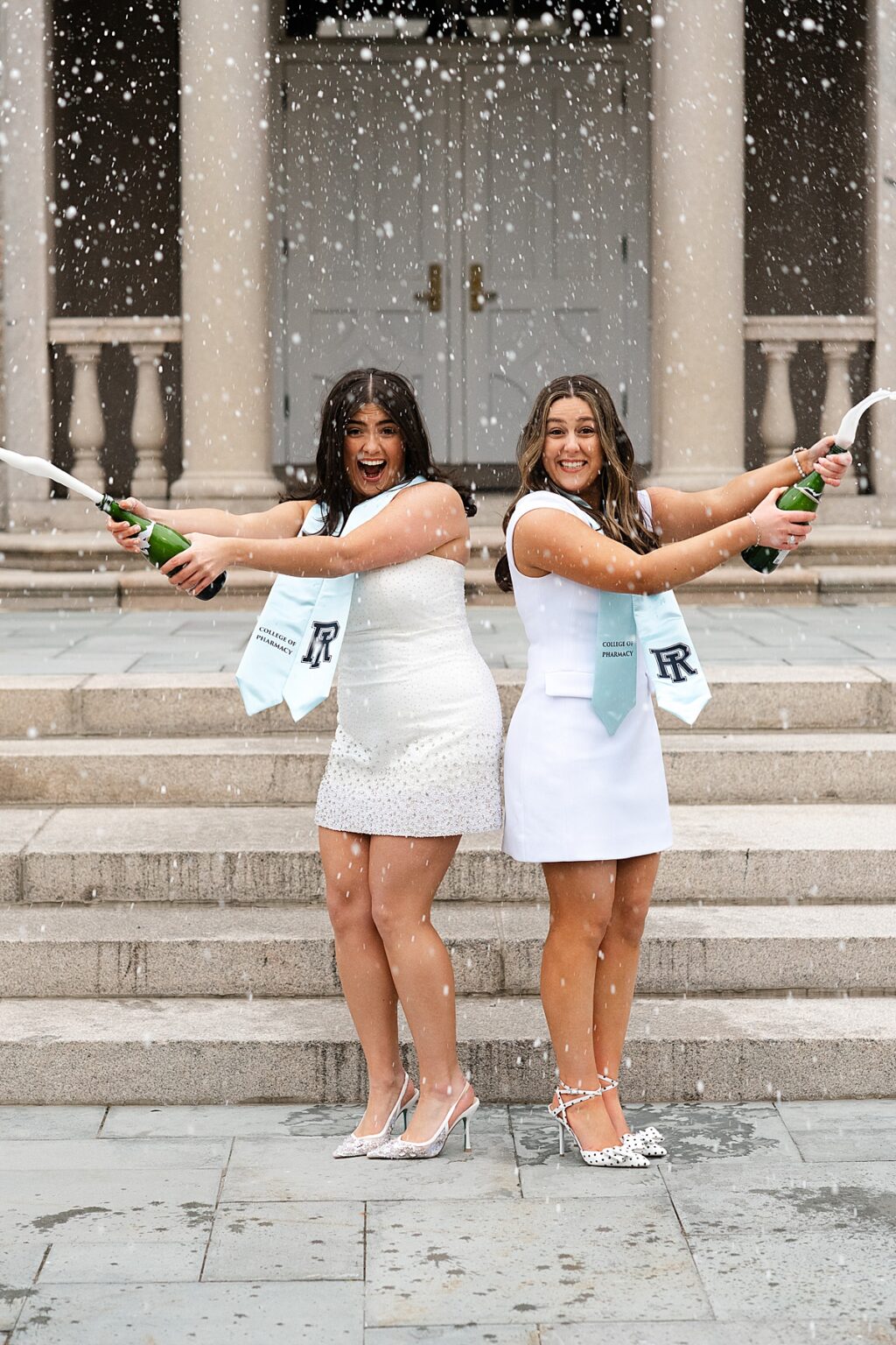URI college graduates spraying champagne