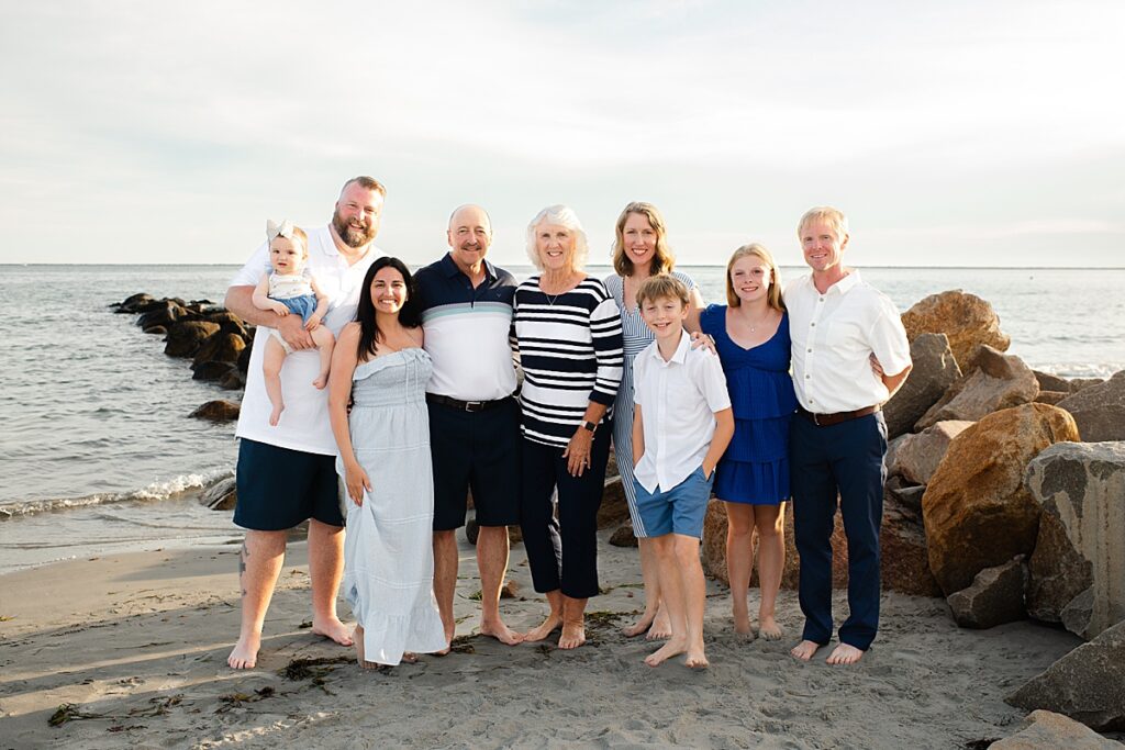 Family smiling together on the shoreline at Roger Wheeler Beach